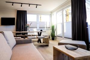 a living room with a couch and a table at Smart Resorts Haus Saphir Ferienwohnung 503 in Winterberg