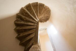 a spiral staircase in a room with a ceiling at Le Cara in Beaune