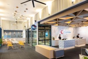 a restaurant with a counter and tables and chairs at Travelodge Phuket Town in Phuket