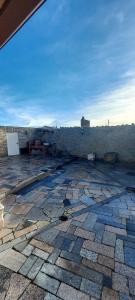 a stone patio with a view of a stone wall at Casa Rural de Tio Tango I in Cardeñosa