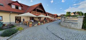 a cobblestone street in front of a building at Hotel Farma Vysoká in Chrastava