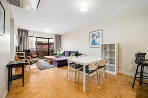 a living room with a table and a couch at Swainson on Union in Adelaide