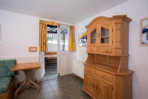 a kitchen with a wooden cabinet and a table at Apartments Baki Kranjska Gora in Kranjska Gora