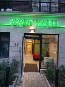 an entrance to an apartment hotel with a green sign at APARTHOTEL BON BON in Sofia