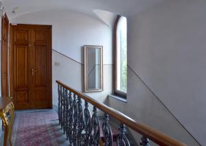 a hallway with stairs and a door and windows at Hotel Arno Bellariva in Florence +38 photos