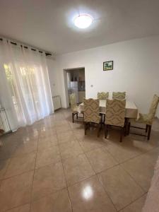 a dining room with a table and chairs at Kampor Apartment 9 in Supetarska Draga