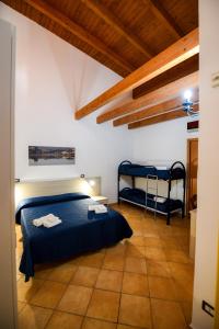 A bed or beds in a room at Giardini Sausari Residence Még 37 kép
