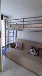 a bedroom with a bunk bed with two pillows at Superbe appartement à 50m des pistes parking privé in La Toussuire