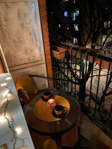 a table with two bowls of food on a balcony at Bella apartment in Belgrade