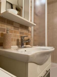 a white sink in a bathroom with a mirror at Bella apartment in Belgrade +19 photos