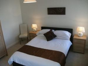 A bed or beds in a room at Falcon's Nest Self Catering Apartments