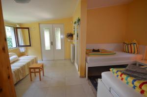 a small room with two beds and a couch at Casa Favorita in Colico +30 photos