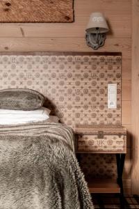 a bedroom with a bed and a lamp at Aries Hotel & SPA Zakopane in Zakopane
