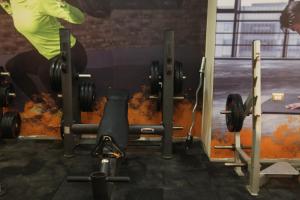 a person in a gym with weights at Jewel Agouza Hotel in Cairo