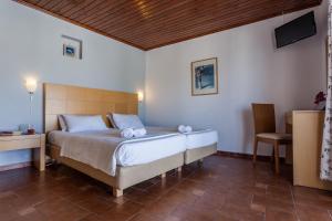 A bed or beds in a room at Argo Pension
