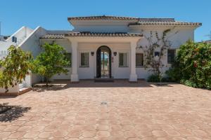 a large white house with a driveway at Villa Orquidea in Benalup Casas Viejas