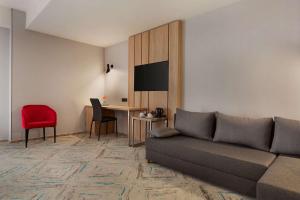 a living room with a couch and a table at Ramada by Wyndham Targu Jiu in Târgu Jiu
