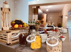 a kitchen counter with jars of food and fruit at Zelena Oaza in Zgornja Kungota