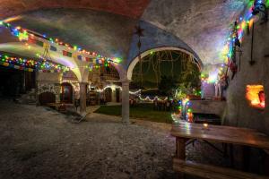 a patio with christmas lights and a wooden bench at Castello di Zorzino Iseo lake in Riva di Solto