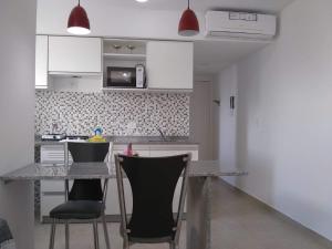 a kitchen with a table and chairs in a room at Pasco 1847 Apartamento 5B in Rosario
