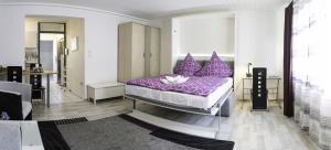 a bedroom with a purple bed with purple pillows at Apart-2-OG-Nr1 in Darmstadt