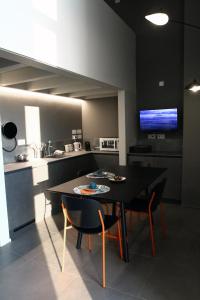 a kitchen with a table and chairs and a television at Dimore al Te in Mantova