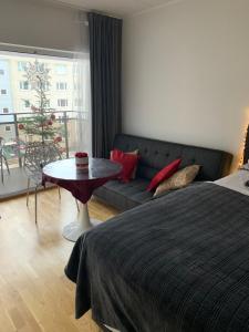 een slaapkamer met een bed, een bank en een tafel bij Oja 118 Apartment in Pärnu