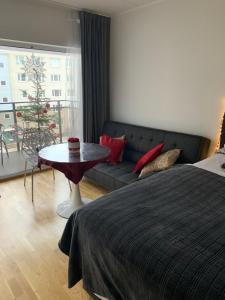 a bedroom with a bed and a couch and a table at Oja 118 Apartment in Pärnu