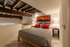 a bedroom with a large bed with red pillows at Navona Pretty Home in Rome