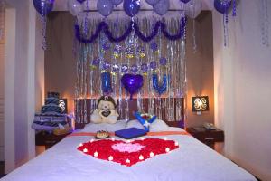 A bed or beds in a room at Helios Hotel Malang