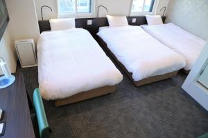 Кровать или кровати в номере Tokyo City View Hotel Tabata Station