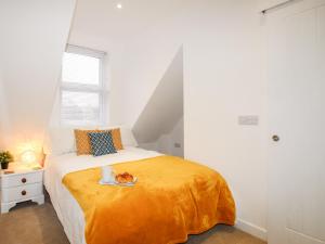 a bedroom with a bed with a plate of food on it at Portside in Weymouth