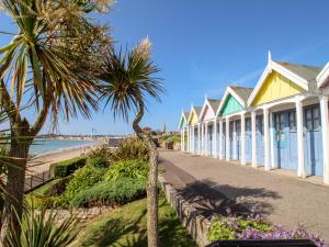 a row of colourful houses on the beach at Portside in Weymouth
