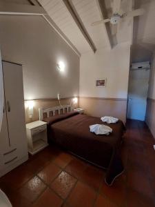 a bedroom with a large bed in a room at Santa Catalina Hotel in San Antonio de Areco