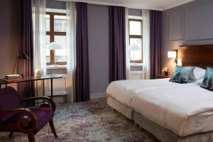 Postel nebo postele na pokoji v ubytování Leopolis Hotel