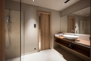 a bathroom with a shower and a sink at Adler Spa Resort Dolomiti in Ortisei