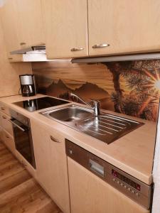 a kitchen with a sink and a stove at Ferienwohnung Lenz in Marktschellenberg