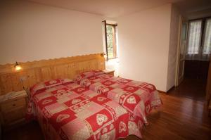 Postel nebo postele na pokoji v ubytování Hotel Aiguille Noire