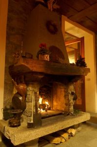 a fire place in the middle of a brick building at Hotel Aiguille Noire in Courmayeur