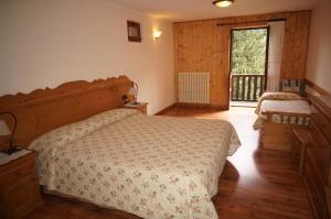 Postel nebo postele na pokoji v ubytování Hotel Aiguille Noire