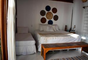 Säng eller sängar i ett rum på Barra Suítes