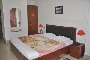 Postel nebo postele na pokoji v ubytování Hotel Dooars Mountain