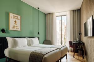 a hotel room with a bed and a window at Hotel Hotel - Member of Design Hotels in Lisbon