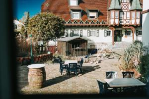 a patio with tables and chairs in front of a house at Astheimer Schlösschen in Trebur