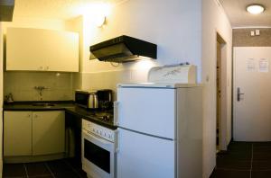 a kitchen with a white refrigerator and a stove at Apart-1-OG-Nr1 in Darmstadt