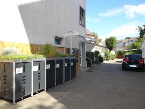 a car parked next to a building with lockers at Apart-1-OG-Nr1 in Darmstadt