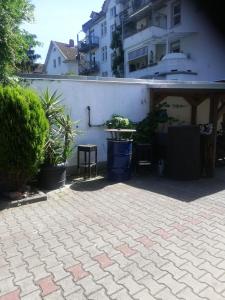 a patio with plants and a white building at Apart-1-OG-Nr1 in Darmstadt