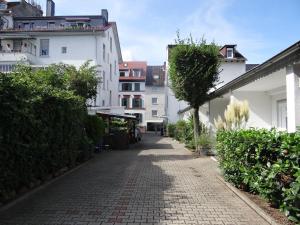 a cobblestone street in a city with white buildings at Apart-EG-01 in Darmstadt