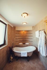 a large bathroom with a tub and a sink at Denisa Boutique in Poiana Brasov