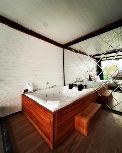 a large bath tub in a room with a large window at SAPANCA KIYI BUNGALOV&CAFE in Sakarya